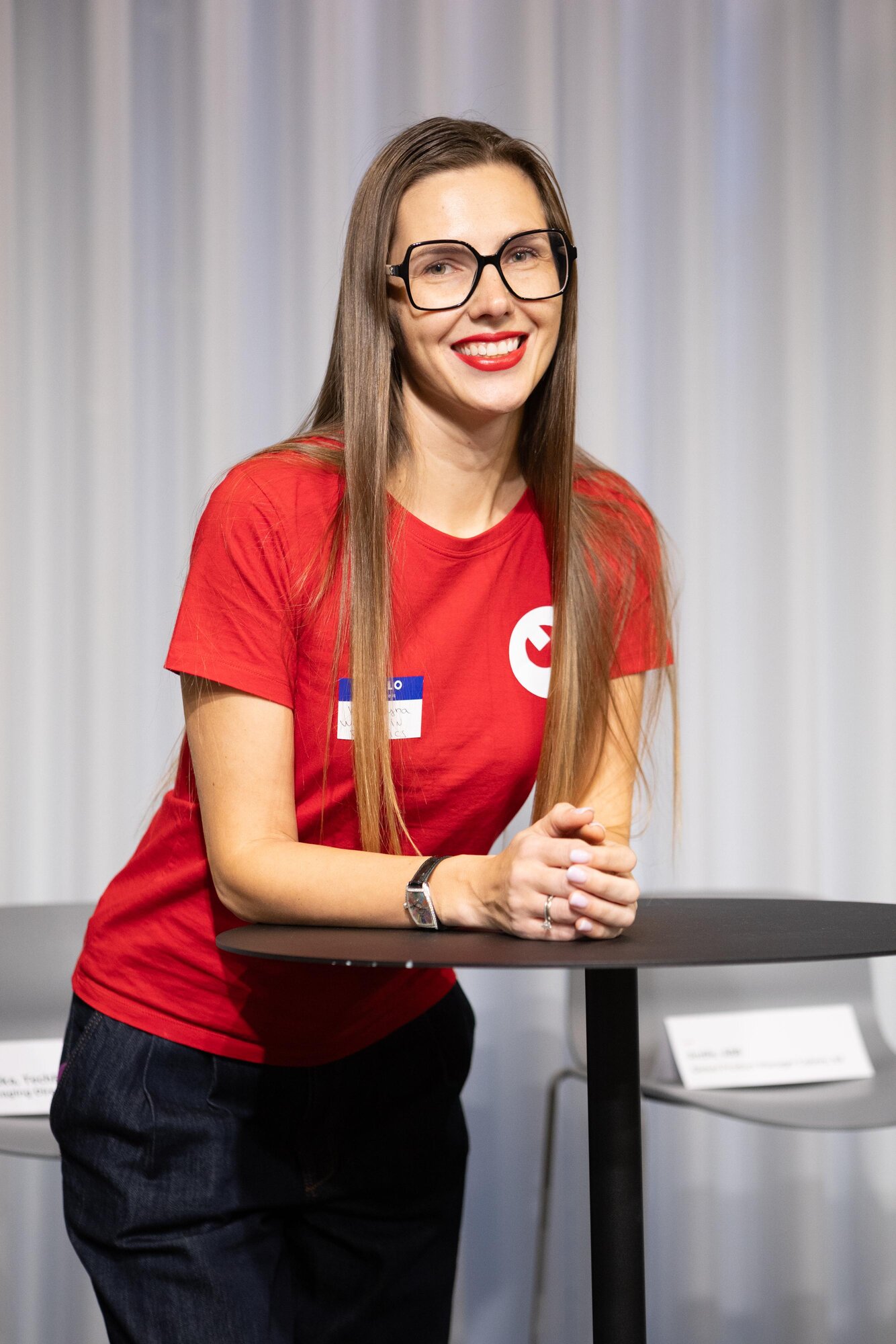 Portrait of Kateryna Portmann at a robotics community event, wearing a red t-shirt